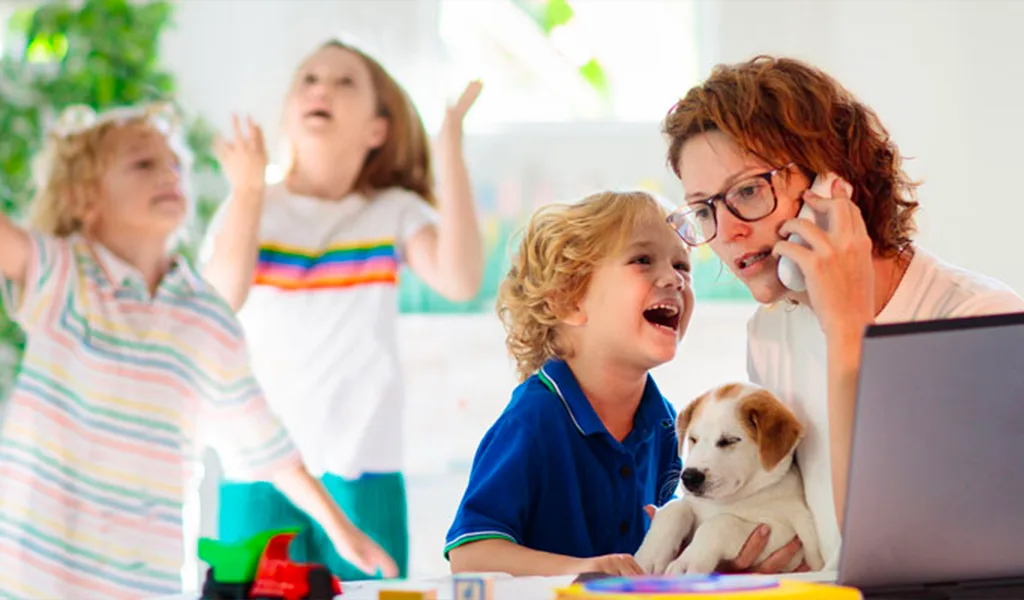 Busy mom on the phone with three children playing around her. How to protect Children's Oral Health Amidst the Back-to-School Chaos